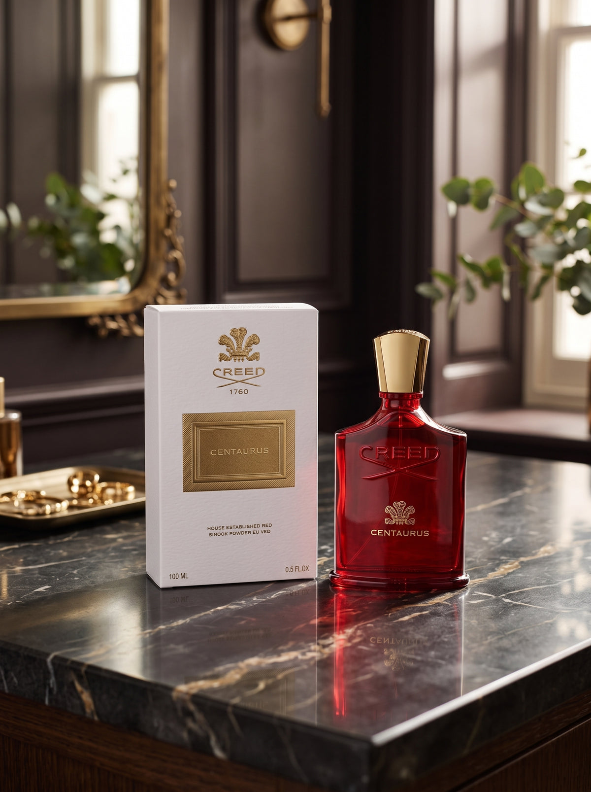 Creed Centaurus Eau de Parfum bottle in red glass with a gold cap, standing next to its white and gold box on a dark marble countertop in an elegant room.