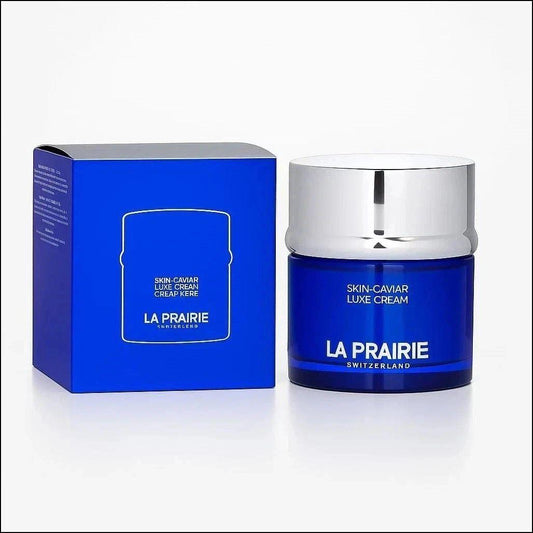 La Prairie Skin-Caviar Luxe Cream in a dark blue jar with a silver lid, shown next to its matching blue box on a white background.