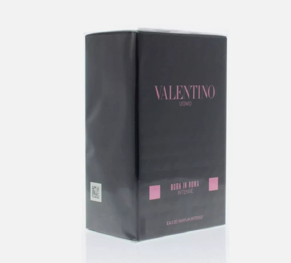 Valentino Uomo Born in Roma Intense Eau de Parfum box in black with pink lettering, shown on a light gray background.