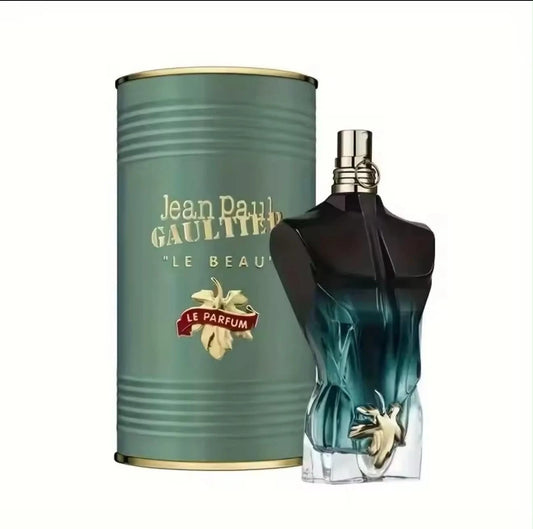 Jean Paul Gaultier Le Parfum fragrance shown with its cylindrical teal-green packaging canister and the sculptural torso-shaped perfume bottle in dark blue-green glass with gold detailing, on a plain white background.